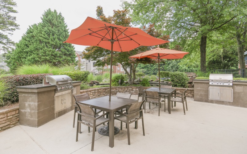 Grilling area with grills and tables with red umbrellas