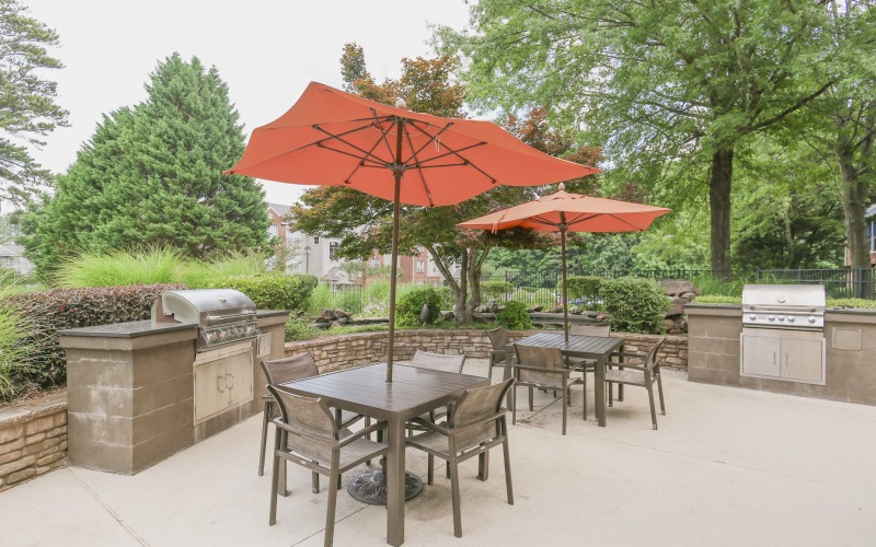 Grilling area with grills and tables with red umbrellas